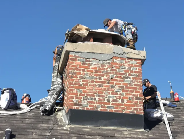 Seekonk Chimney Sweep installing a custom chimney crown in Seekonk, MA